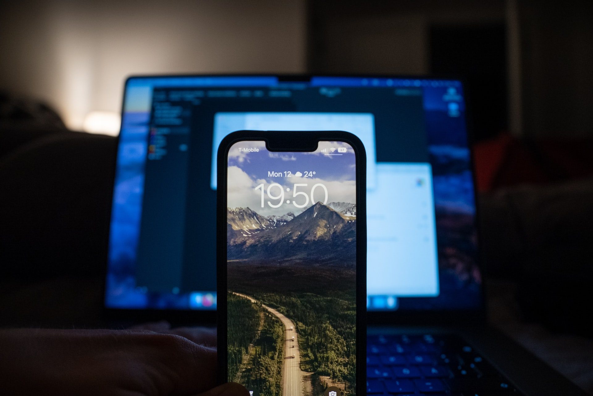 An iPhone in front of a laptop